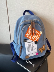 Blue denim backpack with DIY patches and buttons, stylish student rucksack for daily use