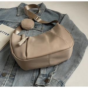Detail of khaki crescent bag with adjustable strap and small round coin purse
