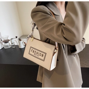 Detail of cream rectangular shoulder bag with silk scarf handle and fashion letter print