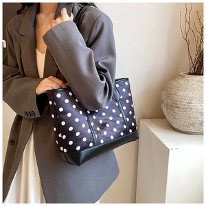 Polka dot tote bag styled with a gray blazer for a minimalist office commuter look