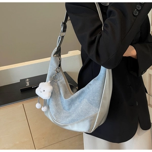 Detail showing denim and silver metallic patchwork moon bag with cute cloud charm
