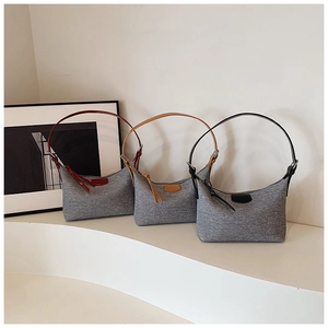 Three colors of minimalist crescent shoulder bags displayed on white pedestals