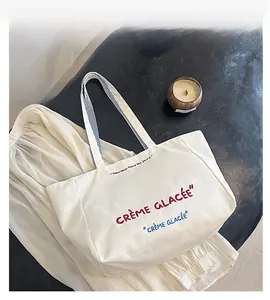 Detail of canvas tote bag with Crème Glacée lettering and elegant interior design