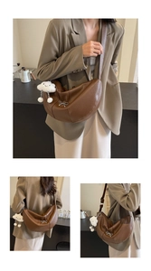 Detail of brown dumpling bag with lychee texture and plush cloud charm accessory