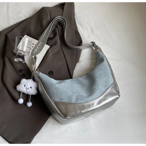 Detail of hobo crossbody bag with denim splicing and cute cloud plush charm