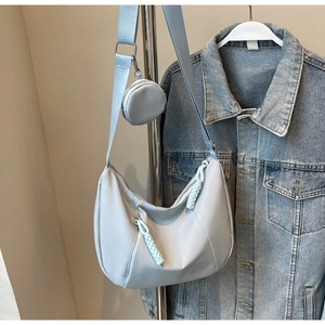 Detail of light blue nylon hobo bag with matching detachable round coin purse on strap