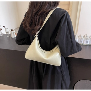 Detailed view of sage green faux leather crescent underarm bag with adjustable strap