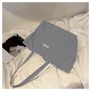 Detailed top view of large striped canvas tote bag with Magic Pocket label