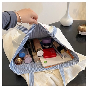 Detailed view of the large canvas tote interior showing spacious storage and striped lining