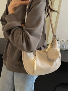 Chic beige half-moon hobo bag with mini round pouch and stylish woven zipper detail