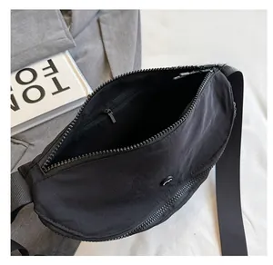 Detail view showing the spacious interior and hidden zipper pocket of the black nylon bag