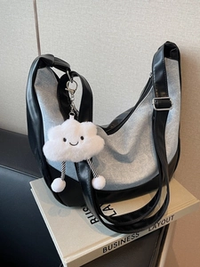 Chic denim patchwork tote bag with cute cloud charm and adjustable shoulder strap