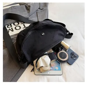 Detail showing the large capacity of this black nylon crescent bag with daily essentials