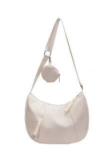 Beige crescent nylon crossbody bag with matching round coin purse and woven zipper pull