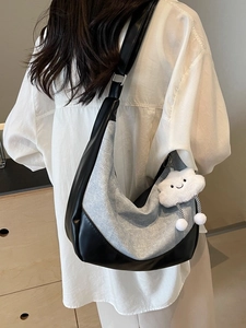Black leather and grey denim half-moon shoulder bag with a white plush cloud charm