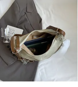 Detail view of spacious interior of canvas tote bag storing a tablet and water bottle