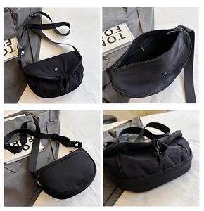 Detail view of the black crescent saddle bag showing the inner pocket and durable nylon fabric