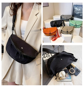Nylon crescent crossbody bag detail showing multiple colors and large internal capacity