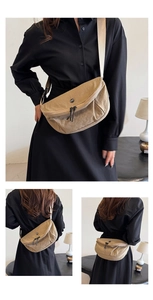 Three-way view of a khaki nylon crescent crossbody bag with minimalist texture