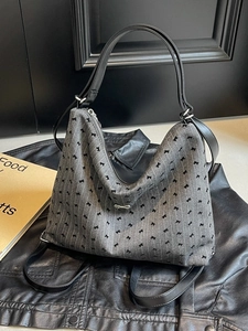 Chic grey striped hobo bag with black bow prints and silver metal hardware accessory
