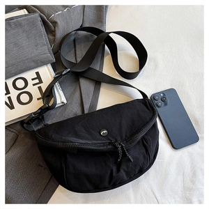 Detail of black nylon crescent saddle bag with dual zippers and adjustable wide strap