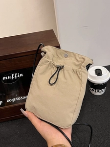 Minimalist khaki canvas crossbody phone bag with drawstring closure in casual daily style