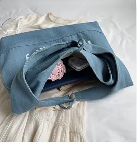 Interior view of large denim tote bag showing spacious storage with magnetic snap closure
