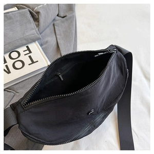 Detailed close-up showing the interior zipper pocket and nylon texture of the crossbody bag