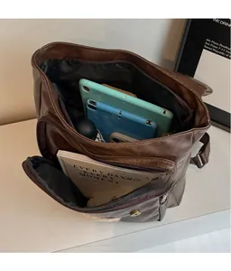 Internal compartments of vintage brown faux leather backpack showing large storage capacity
