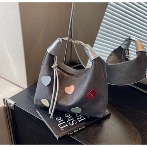 Detailed view of dark grey suede hobo bag with colorful 3D heart-shaped accents