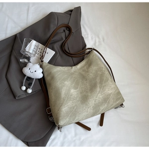 Detail of vintage pale green marble textured tote bag with cute cloud charm