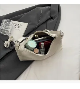 Top view of spacious cream leather shoulder bag interior showing daily essentials storage