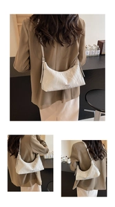 Detail of white pleated hobo bag with adjustable strap and textured glossy finish