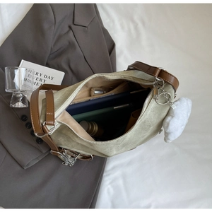 Top view of spacious canvas tote with leather straps showing organized interior items