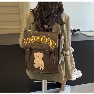 Vintage dark brown leather backpack featuring teddy bear and Holiday embroidery