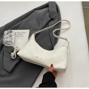 Detailed macro view of white marble texture on synthetic leather crescent underarm bag