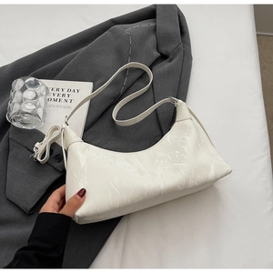 Detail shot of white marble textured underarm bag with zipper closure and dual straps