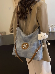 Blue denim hobo backpack with leather straps and cloud charm accessory for women