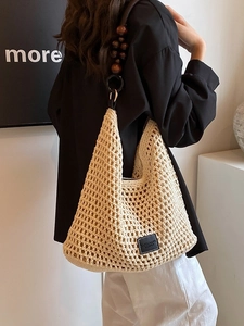 Chic cream crochet woven tote bag with wooden bead straps for summer beach vacation