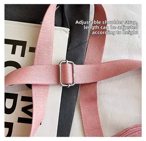 Detail of pink adjustable nylon shoulder strap with a silver metal buckle for comfort