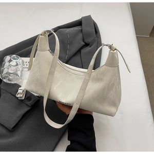 Close-up of white marble texture leather on underarm bag with silver hardware and logo