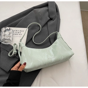 Detail of mint green marble texture underarm bag with removable shoulder straps