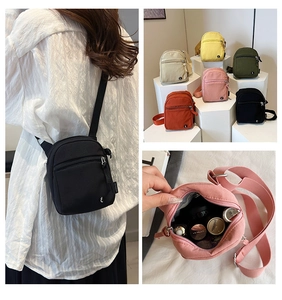 Detail view of mini nylon crossbody bags showing internal capacity and color selection