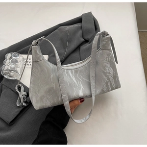 Close-up of the silver-grey wrinkled texture and logo detail on the premium hobo bag