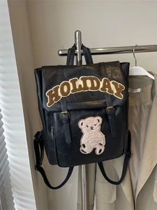 Retro black leather backpack with Holiday embroidery and bear patch on a hanger