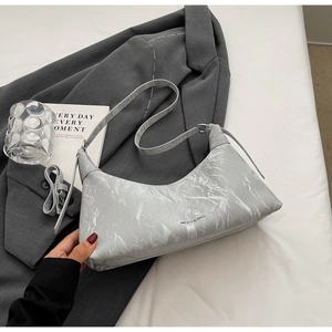 Detail of silver marble textured underarm bag with adjustable strap and front logo