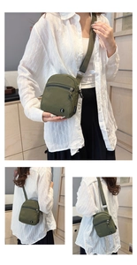 Detail view of military green canvas crossbody bag with branded logo and front zipper pocket