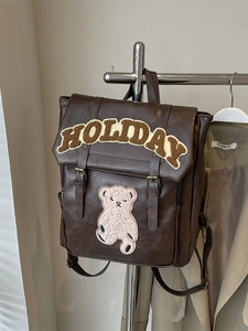 Vintage dark brown faux leather backpack with plush bear patches and adjustable straps