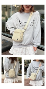 Detail of beige canvas crossbody bag with double zippers and adjustable strap for sports