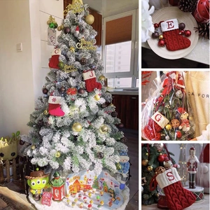 Detail of red and white cable-knit Christmas stockings with personalized alphabet prints